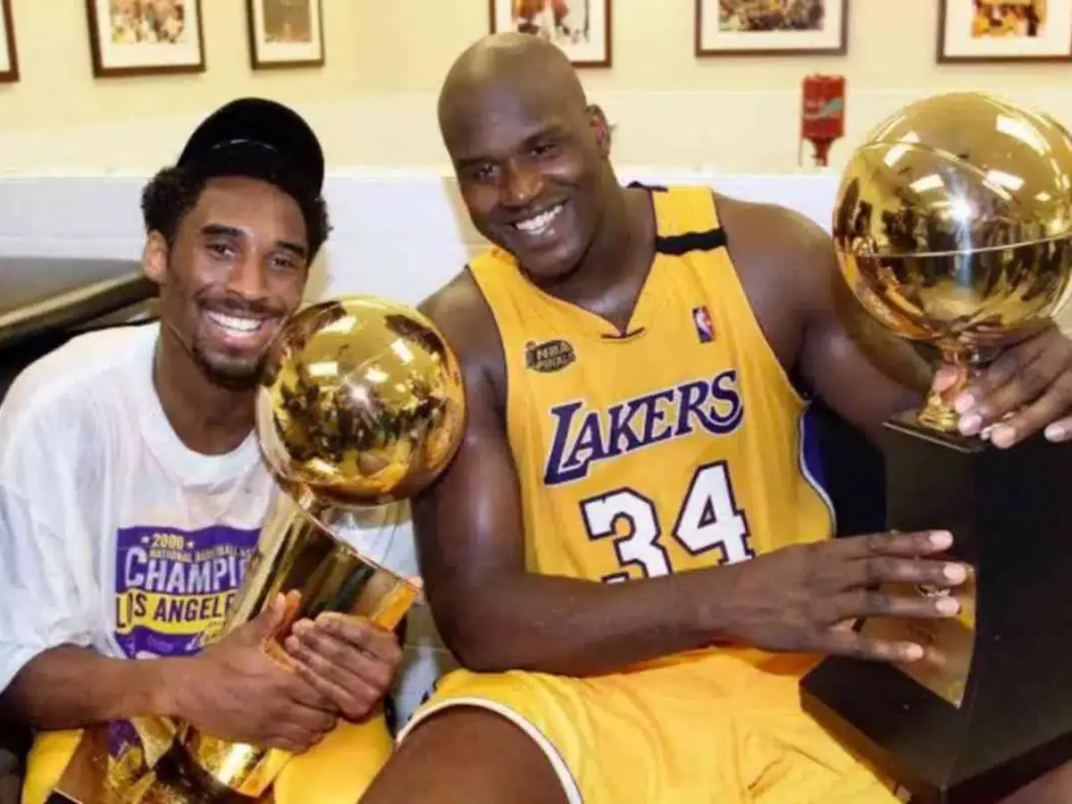 Kobe Bryant and Shaquille O'Neal with their first Championship trophy 