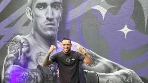 Charles Oliveira with his mural